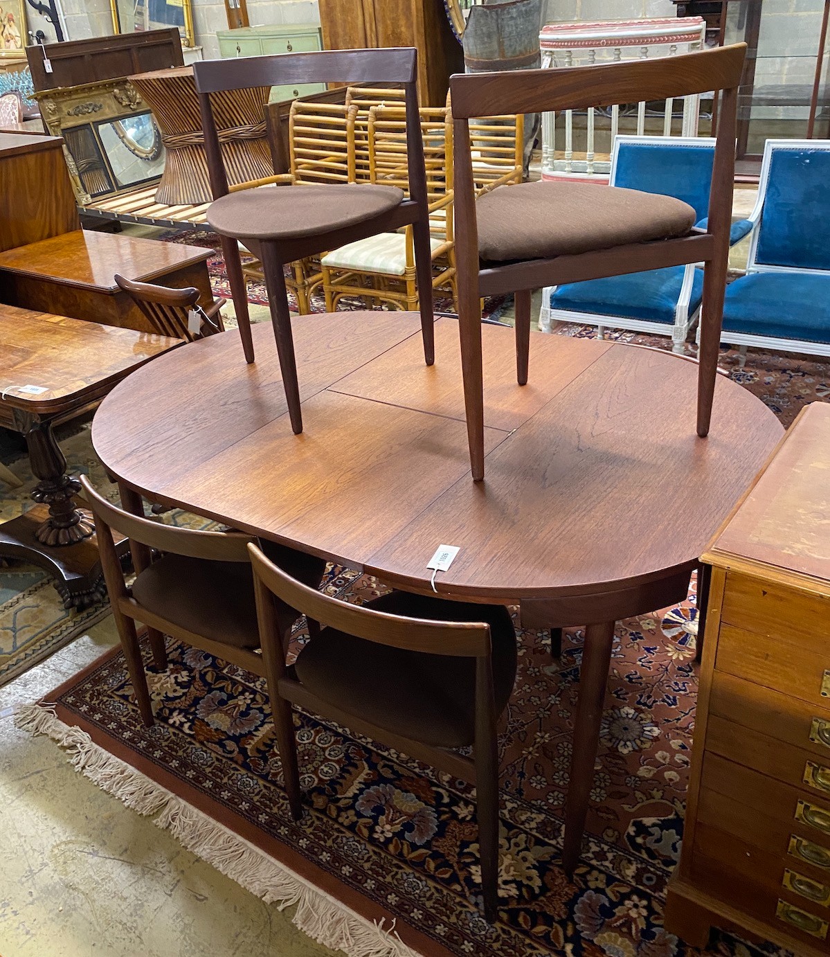 Hans Olsen for Frem Røjle a mid century teak extending dining table, length 156cm extended, depth 106cm, height 73cm and six chairs, chairs stamped to underside.